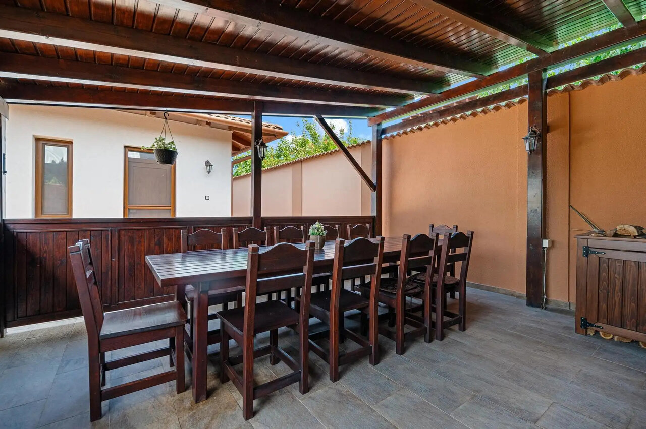 Covered terrace with rustic dining set