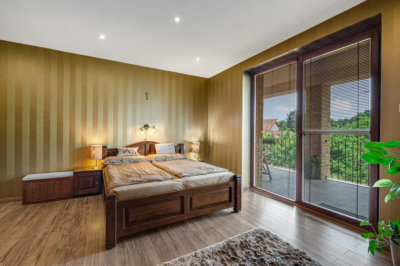 Bright bedroom with double bed and balcony