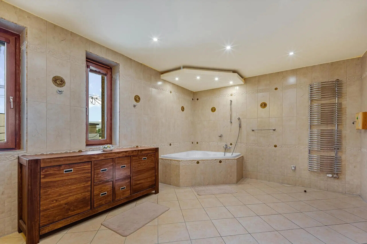 Renovated bathroom with corner bathtub