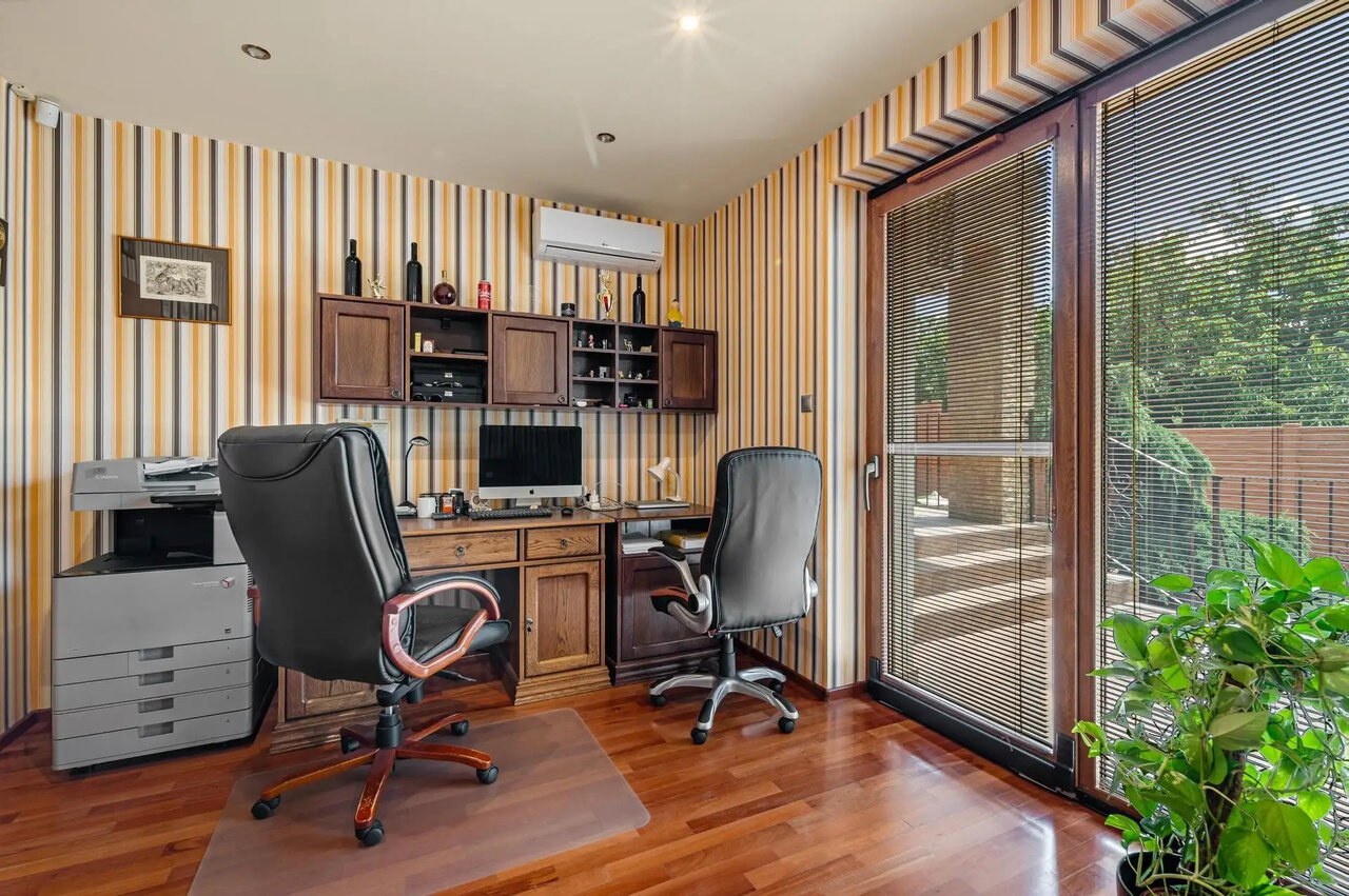 Modern office with glass door and garden view