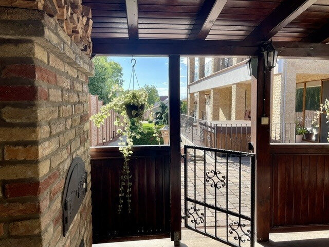 Covered terrace with oven door and wrought iron gate